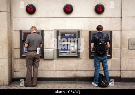 People getting cash at National Westminster Bank cash machines, London UK Stock Photo