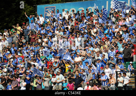 Brighton and Hove Albion football fans cheer their team on to the pitch at the Withdean stadium Stock Photo