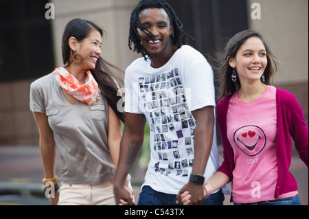 Man with his friends crossing road Stock Photo