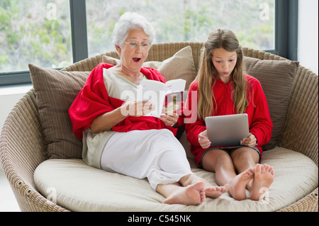Senior woman and her granddaughter looking surprised Stock Photo
