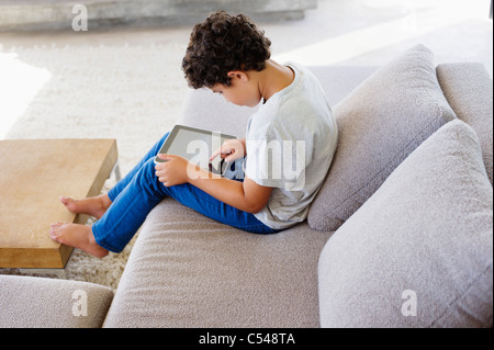 Side profile of a boy using a digital tablet Stock Photo