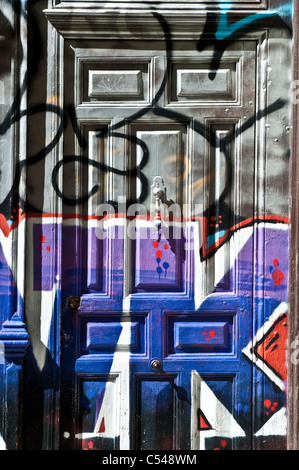 Graffiti on a door, Malasana, Madrid, Spain Stock Photo