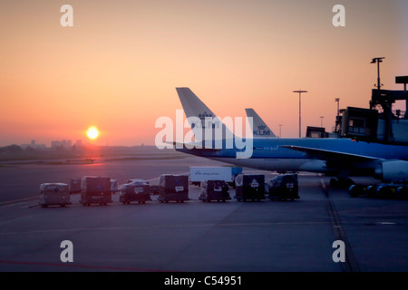 The Netherlands, Amsterdam, KLM airplanes at Schiphol Airport at sunrise. Stock Photo
