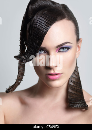 Beauty portrait of a young woman with a creative hairstyle Stock Photo