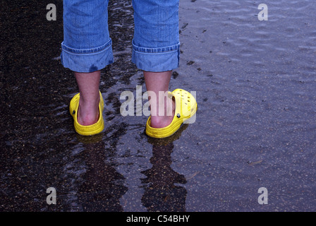 Woman wearing yellow water shoes Stock Photo