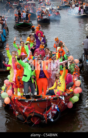 The Netherlands, Amsterdam. Kingsday is a unique night and day carnival like event on 30th of April each year. Canal parade. Stock Photo