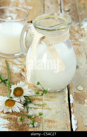 pitcher of milk on a wooden table rustic still life Stock Photo