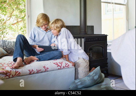 Children using digital tablet at house Stock Photo