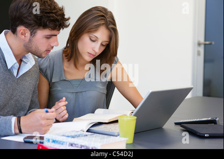 University students using laptop in classroom Stock Photo