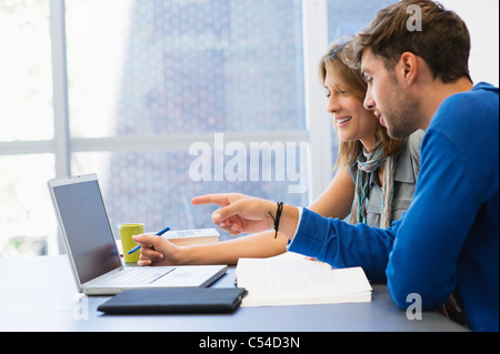 University students using laptop in classroom Stock Photo