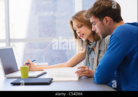 University students using laptop in classroom Stock Photo