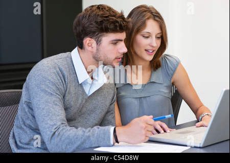 University students using laptop in classroom Stock Photo