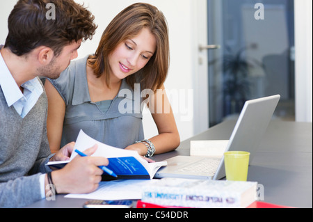 University students using laptop in classroom Stock Photo