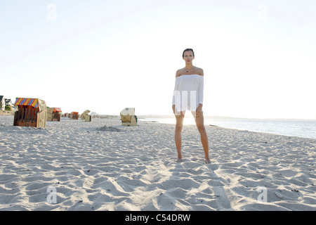 Young woman, 20+, standing on a sandy beach, lifestyle, sensuality, Niendorf at the Baltic Sea, Schleswig-Holstein, Germany