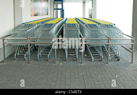 A lot of shopping carts on front of shop Stock Photo