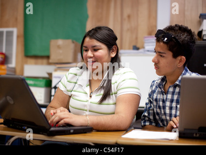 Hispanic high school students work together using laptop computer in El Paso, Texas classroom Stock Photo