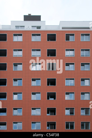 Red building with many windows. Opened and closed windows Stock Photo
