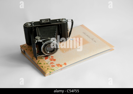 Photo album and vintage camera isolated on white Stock Photo