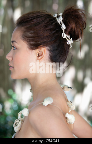 Side profile of a beautiful young woman wearing a shell necklace Stock Photo