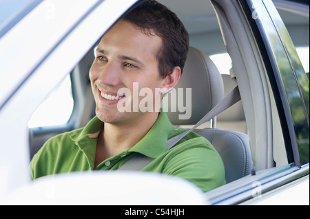 Smiling mid adult man driving a car Stock Photo