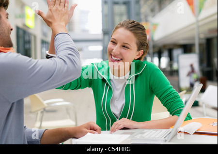 Friends giving each other high-five Stock Photo