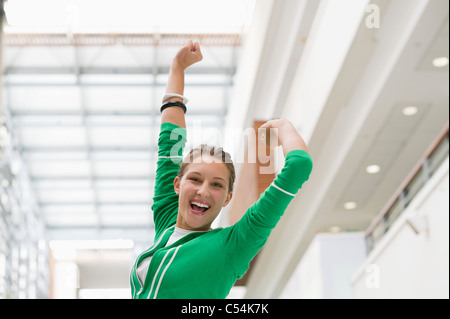 Portrait of an excited woman with arms raised Stock Photo