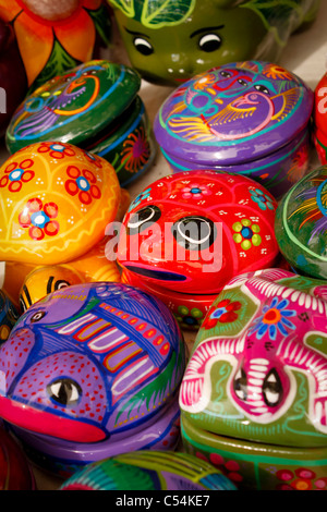 Colorful jewelry boxes with intricate hand-painted detailing on display at open market. Motifs include frogs, flowers and lizard Stock Photo