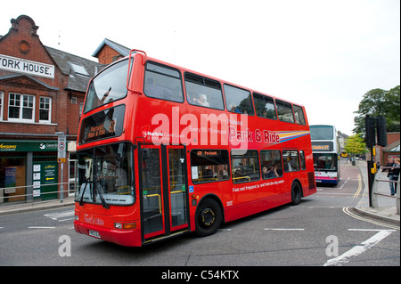 Red double decker park and ride bus driving through Norwich city centre, Norfolk, England. Stock Photo