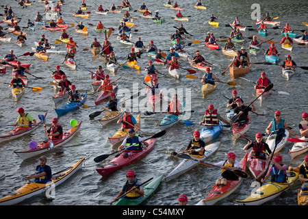 The Netherlands, Amsterdam, sailing event SAIL, celebrated every 5 years. SAIL-2010. Group of people in kayak. Stock Photo