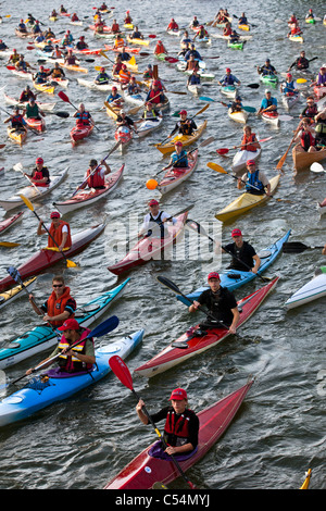 The Netherlands, Amsterdam, sailing event SAIL, celebrated every 5 years. SAIL-2010. Group of people in kayak. Stock Photo