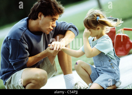 Father consoling his crying daughter Stock Photo