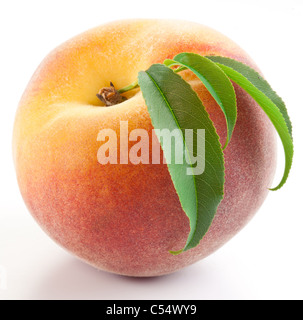 Ripe peach with leaves isolated on a white background. Stock Photo