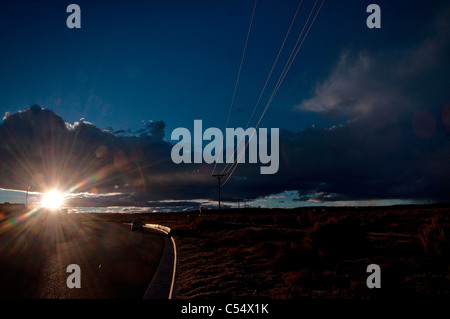 USA, New Mexico, electricity pylons and power lines on desert in afternoon light Stock Photo