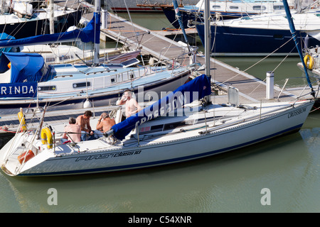 Men sitting on yacht deck Stock Photo