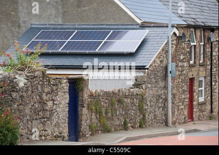 Solar panels on roof of terraced cottage in village of Llangattock Powys South Wales UK Stock Photo
