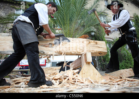 Carpenters in traditional clothing at work, Berlin, Germany Stock Photo