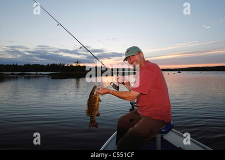 Mature man bass fishing in a lake Stock Photo