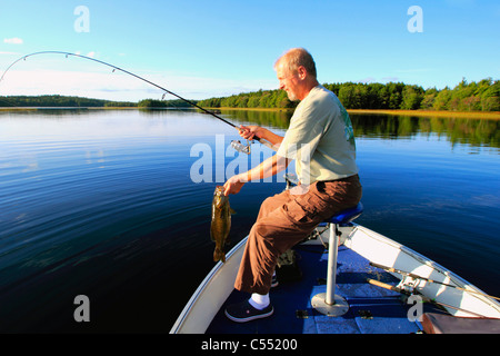 Mature man bass fishing in a lake Stock Photo