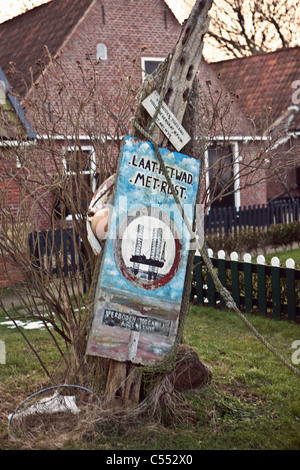 Moddergat, Sign protesting against drilling for oil and gas in nearby Wadden sea, which is a Unesco World Heritage Site. Stock Photo