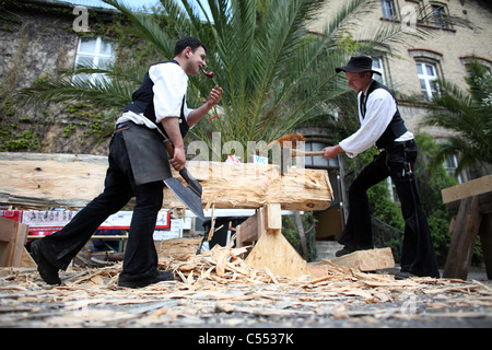 Carpenters in traditional clothing at work, Berlin, Germany Stock Photo