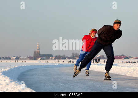 The Netherlands, Hindeloopen, Dutch capital of skating culture. Ice skating on lake called IJsselmeer. Stock Photo