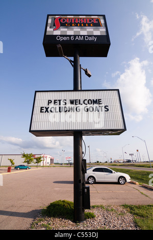 A funny sign in Nebraska that reads 'Pets Welcome, Excluding Goats' Stock Photo