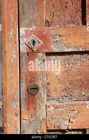 Fragment of an old, shabby brown door, two keyholes Stock Photo