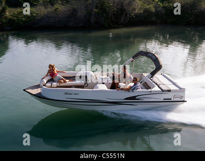 High angle view of two young women and two young men riding in a motorboat Stock Photo
