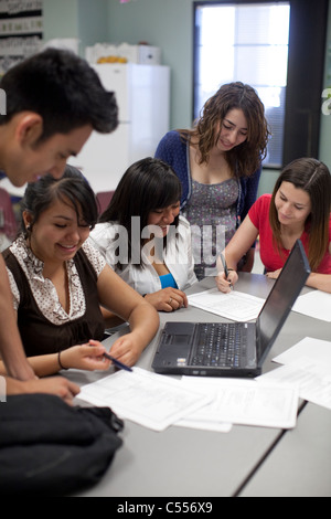 Male and female students use a laptop computer to collaborate on a class project at Mission Early College High School in El Paso Stock Photo