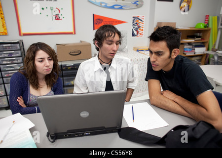 Male and female students use a laptop computer to collaborate on a class project at Mission Early College High School in El Paso Stock Photo