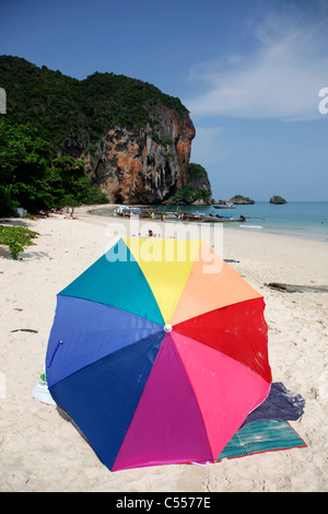 Colourful rainbow holiday umbrella on Phra Nang Cave Beach Railay, Krabi, Thailand Stock Photo