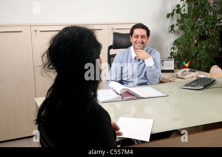 Business man and woman talking inside office Stock Photo