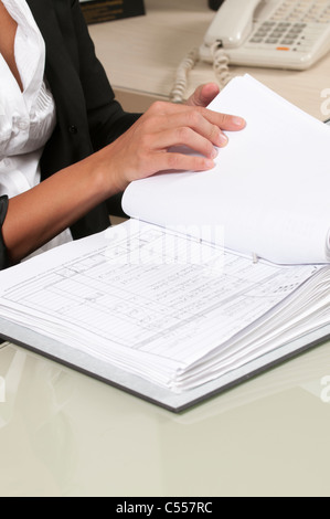 Business woman reviewing report in office Stock Photo
