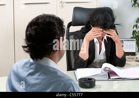 Business woman reading reports with employee Stock Photo